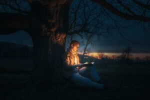 reading book by tree